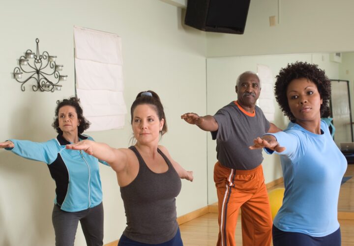 Middle age and senior people taking yoga class