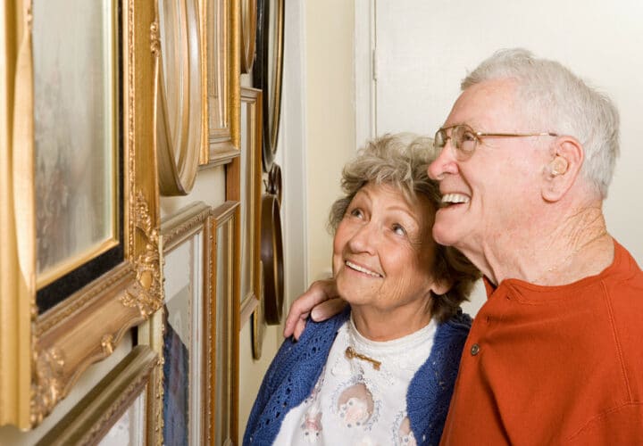 Senior couple looking at art work in museum