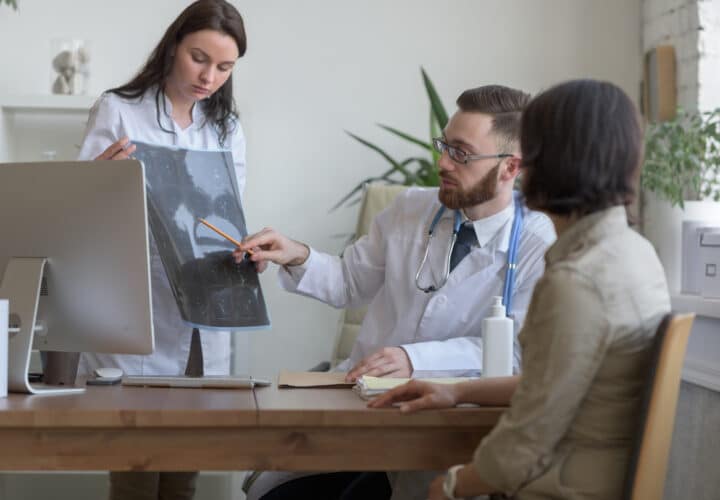 Doctor reviewing brain scans with colleagues