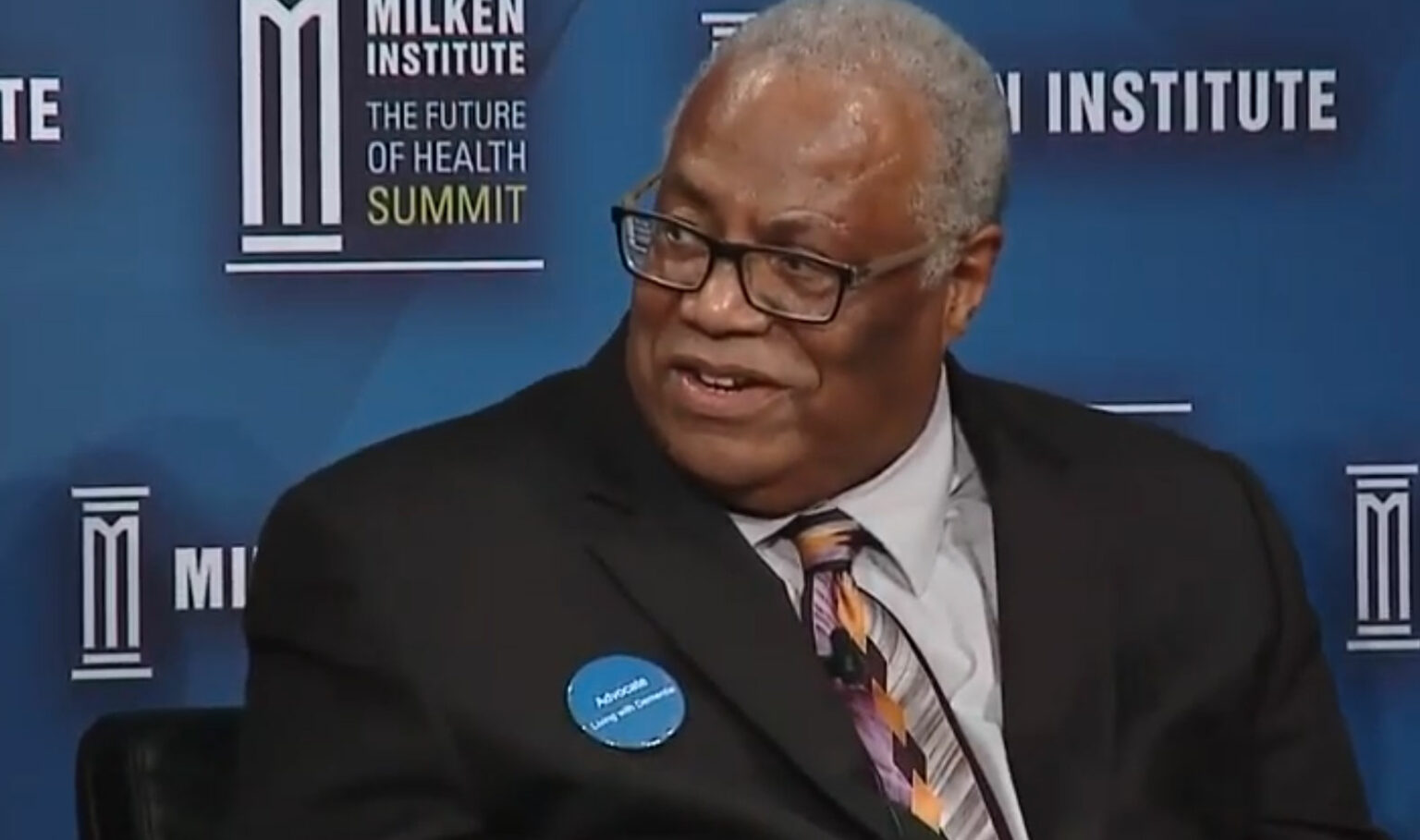 Brian Van Buren speaking on a Milken Institute panel in 2018.