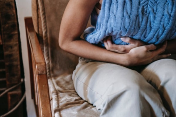 Woman clutching stomach